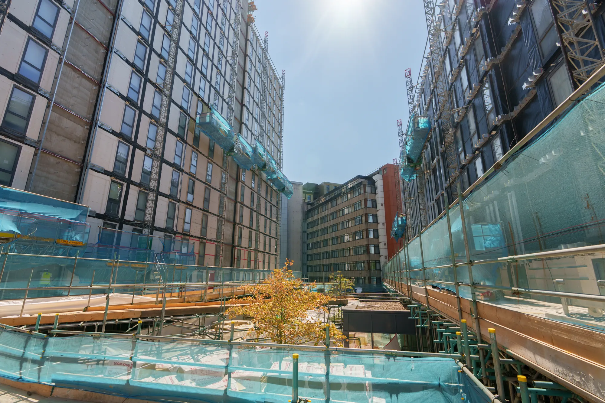 ukr-facades-grand-felda-house-wembley-project-10 Construction-stage view between multi-storey residential buildings at Grand Felda House in Wembley