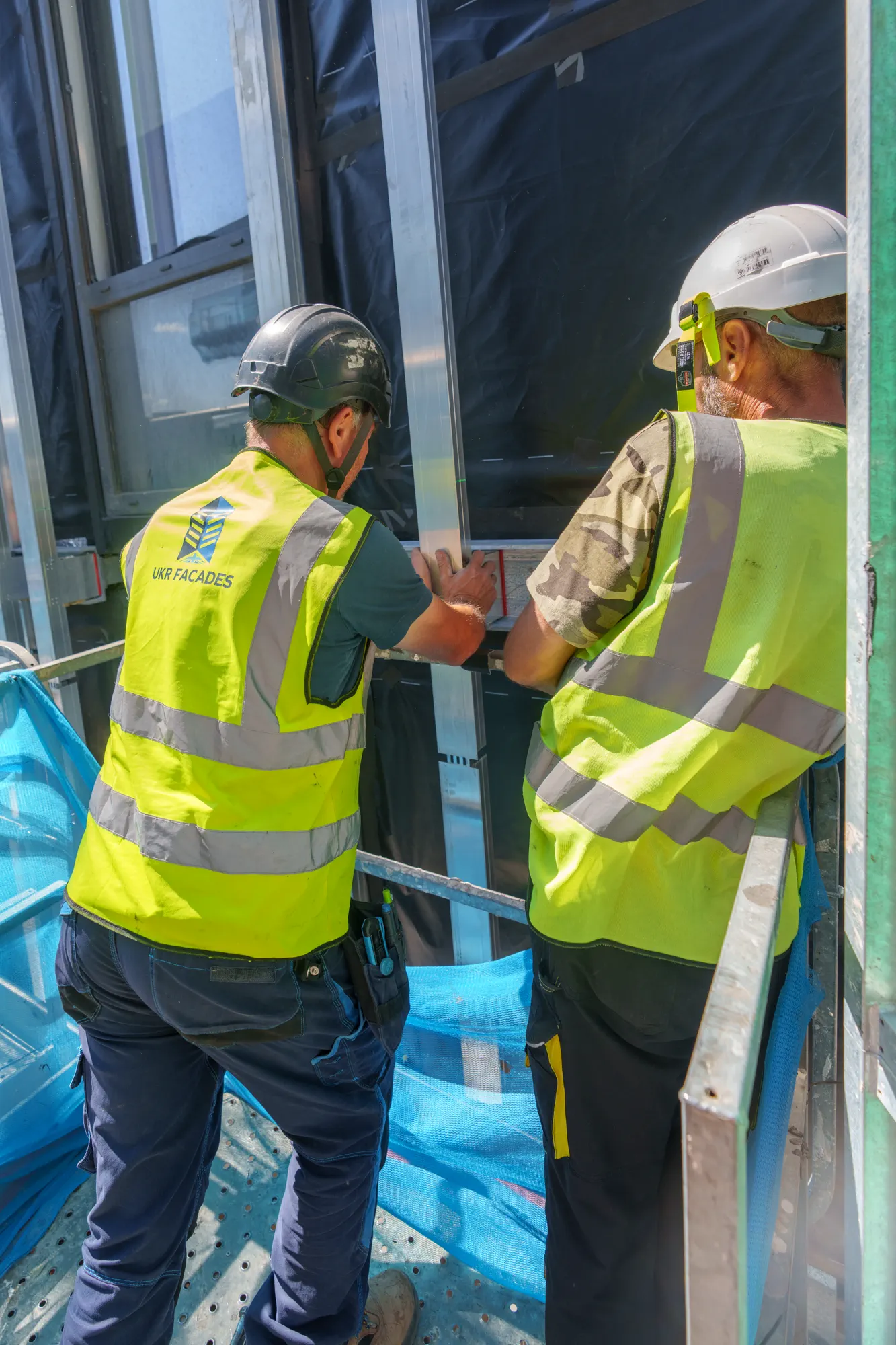 UKR Facades team inspecting facade installation details at Grand Felda House development in Wembley