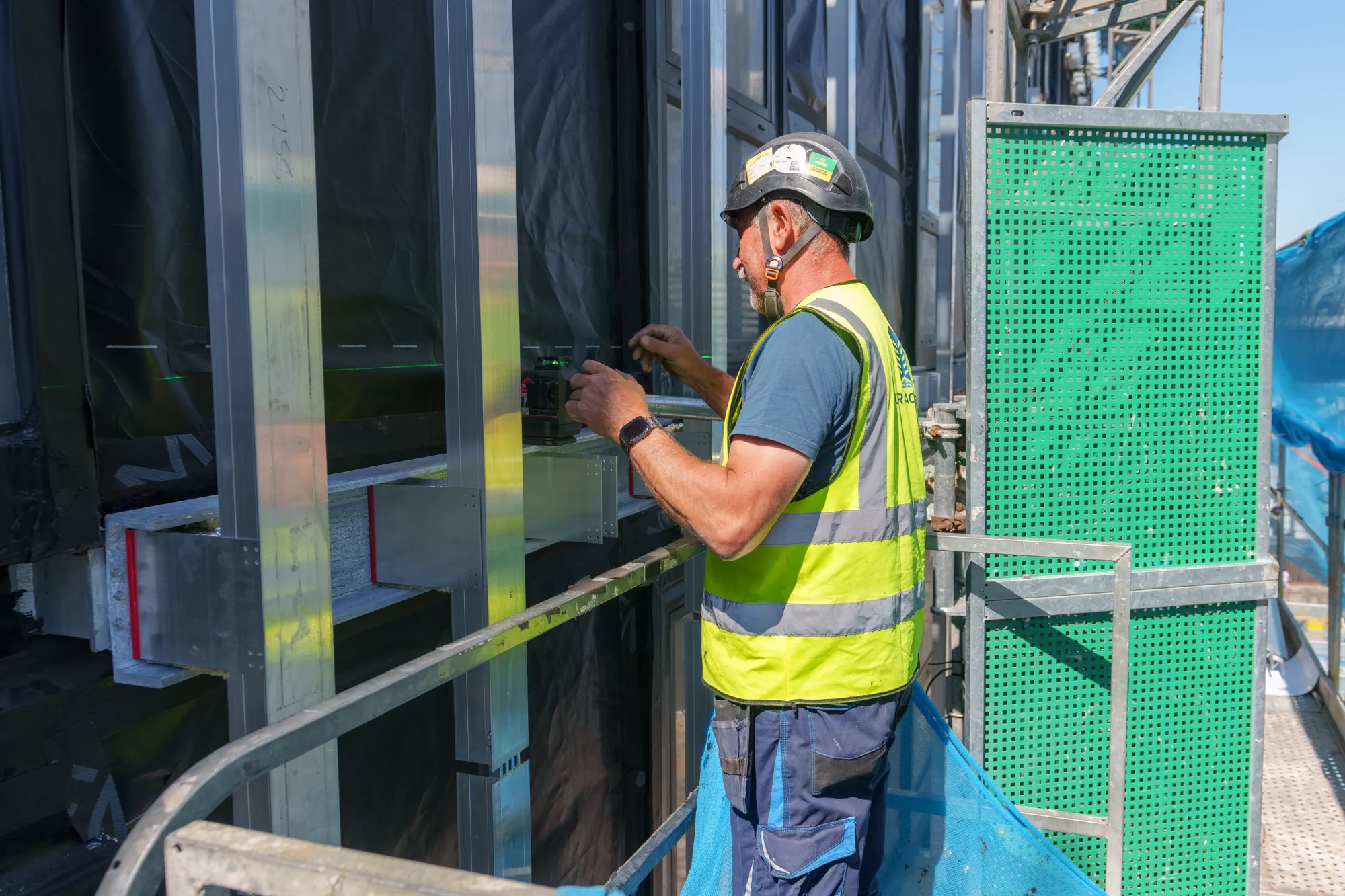 UKR Facades operative measuring facade installation details at Grand Felda House in Wembley