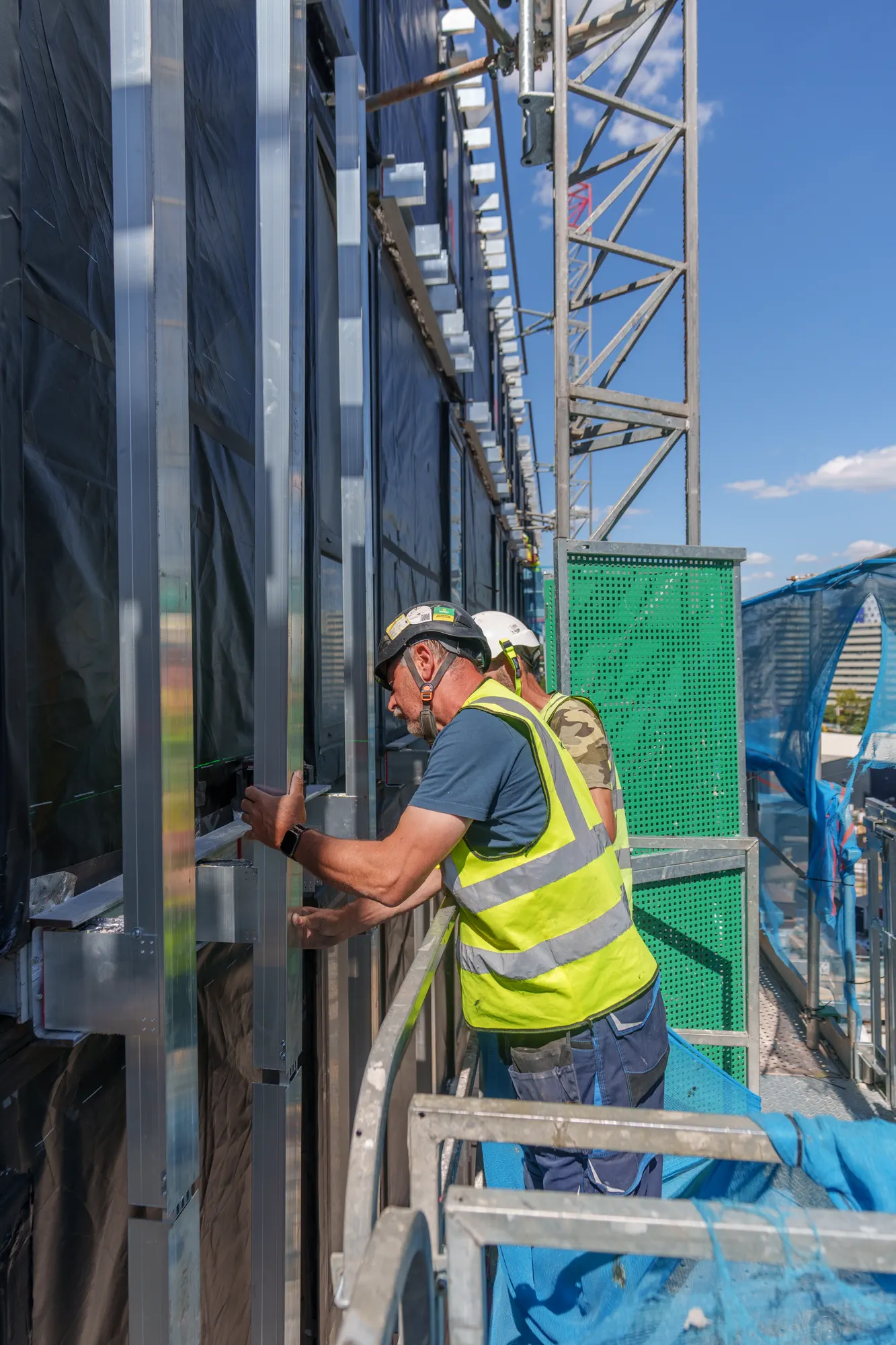ukr-facades-grand-felda-house-wembley-project-29 Detailed facade installation underway from external access equipment at Grand Felda House in Wembley