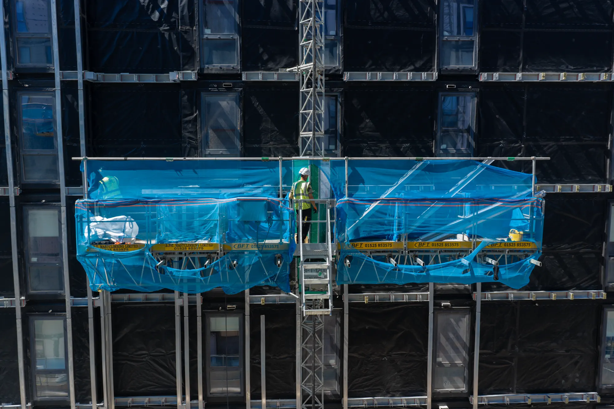 ukr-facades-grand-felda-house-wembley-project-aerial-19 Mast climbers positioned across the facade during construction of Grand Felda House in Wembley