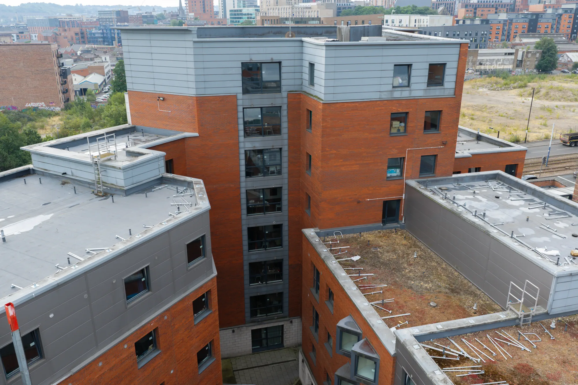 ukr-facades-sheffield-3-sheffield-project-aerial-6 Multi-storey residential buildings at 80 Hoyle Street in Sheffield showing brick elevations and contrasting grey facade sections