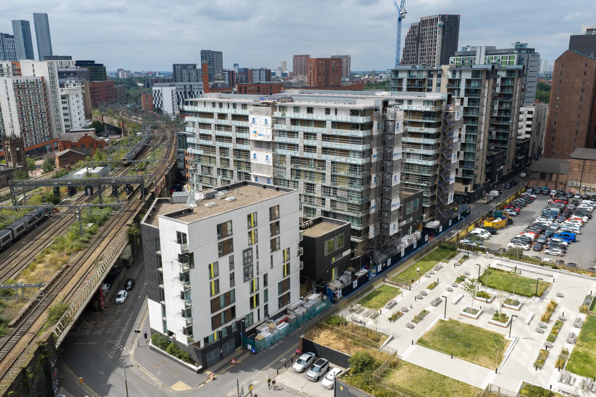 Wide aerial view of Spectrum Apartments within the surrounding Salford residential and city landscape
