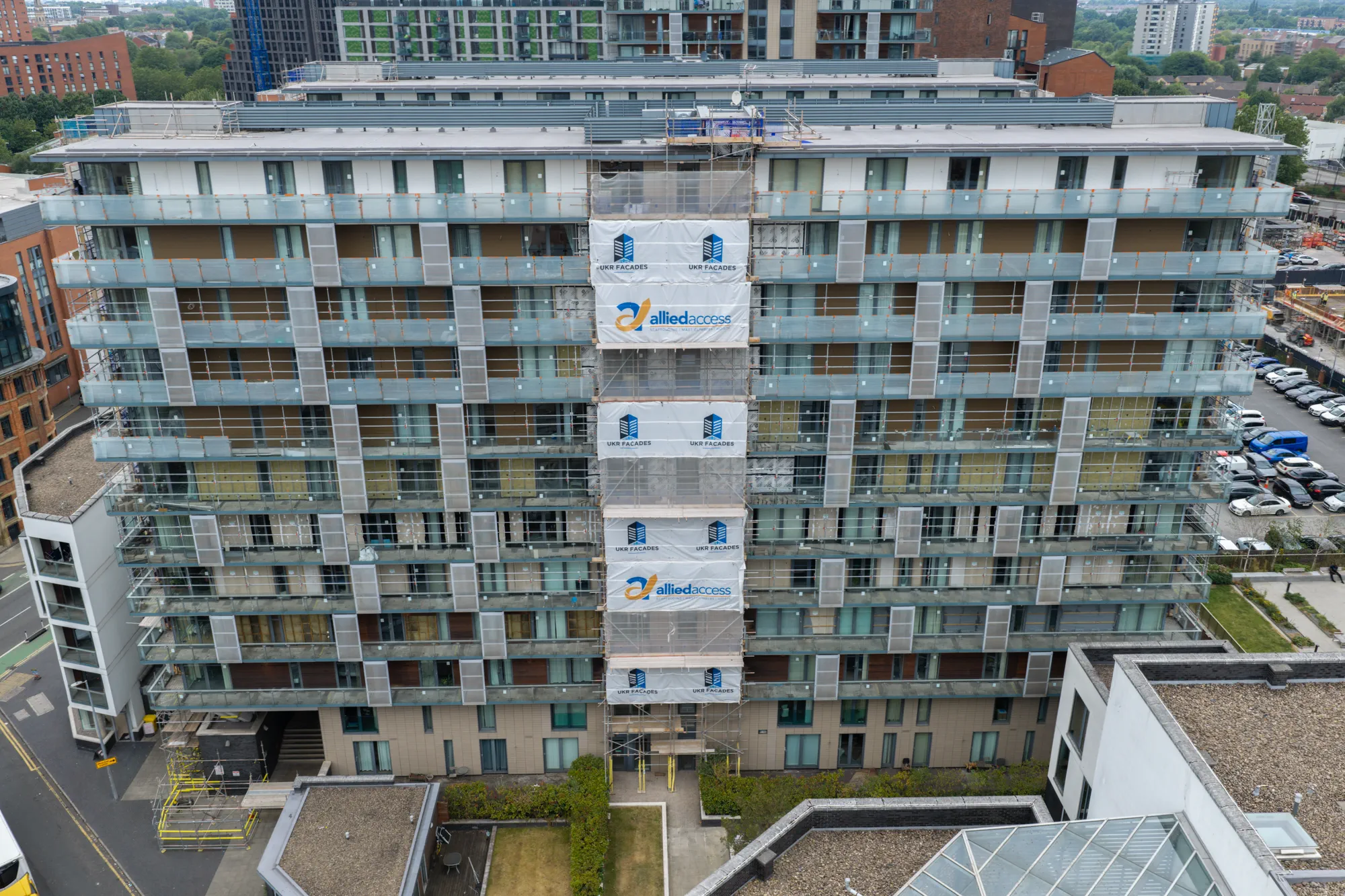 ukr-facades-spectrum-apartments-salford-project-aerial-33 Front aerial view of the residential elevation undergoing facade remediation at Spectrum Apartments in Salford