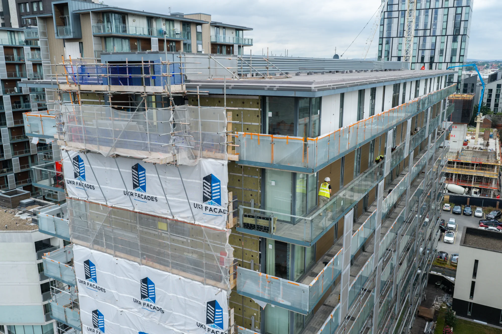 Scaffolding and facade works around the upper residential elevations at Spectrum Apartments in Salford
