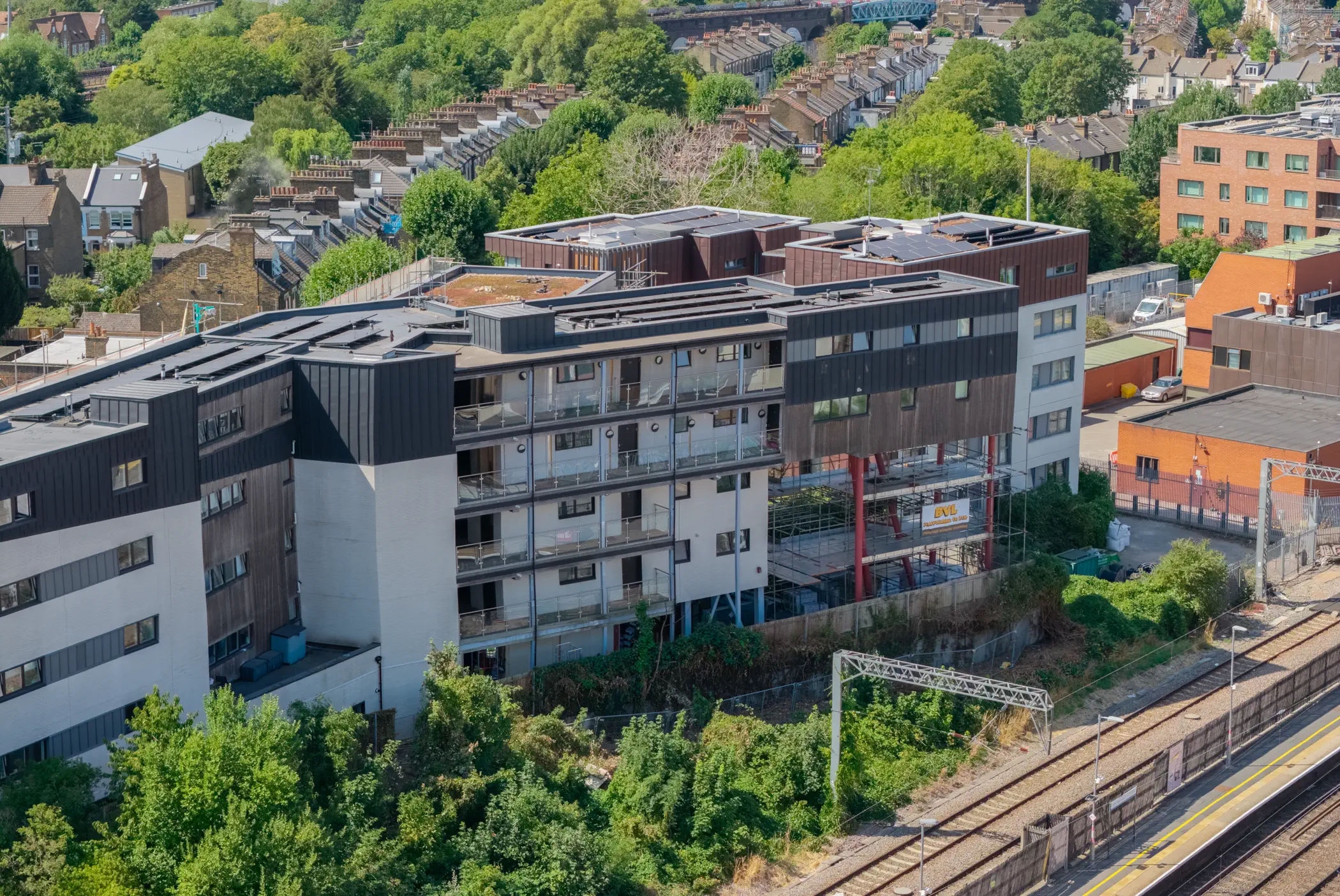 ukr-facades-the-central-london-project-aerial-13 Aerial view of The Central in London showing the multi-storey residential facade beside the railway