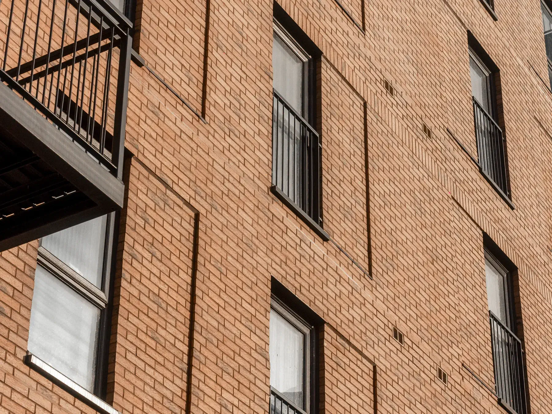 Close-up of completed brick slip facade, windows and balconies at Bridgewater Wharf